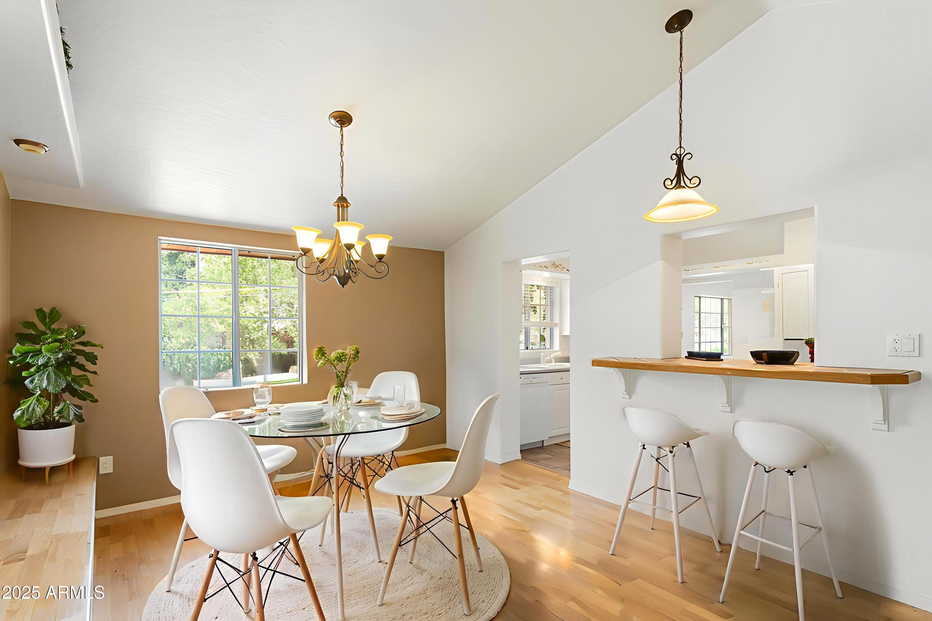 706 Shattuck Street Bisbee, AZ 85603 - Photo 16 of 55 a dining room filled chandelier and wooden floor