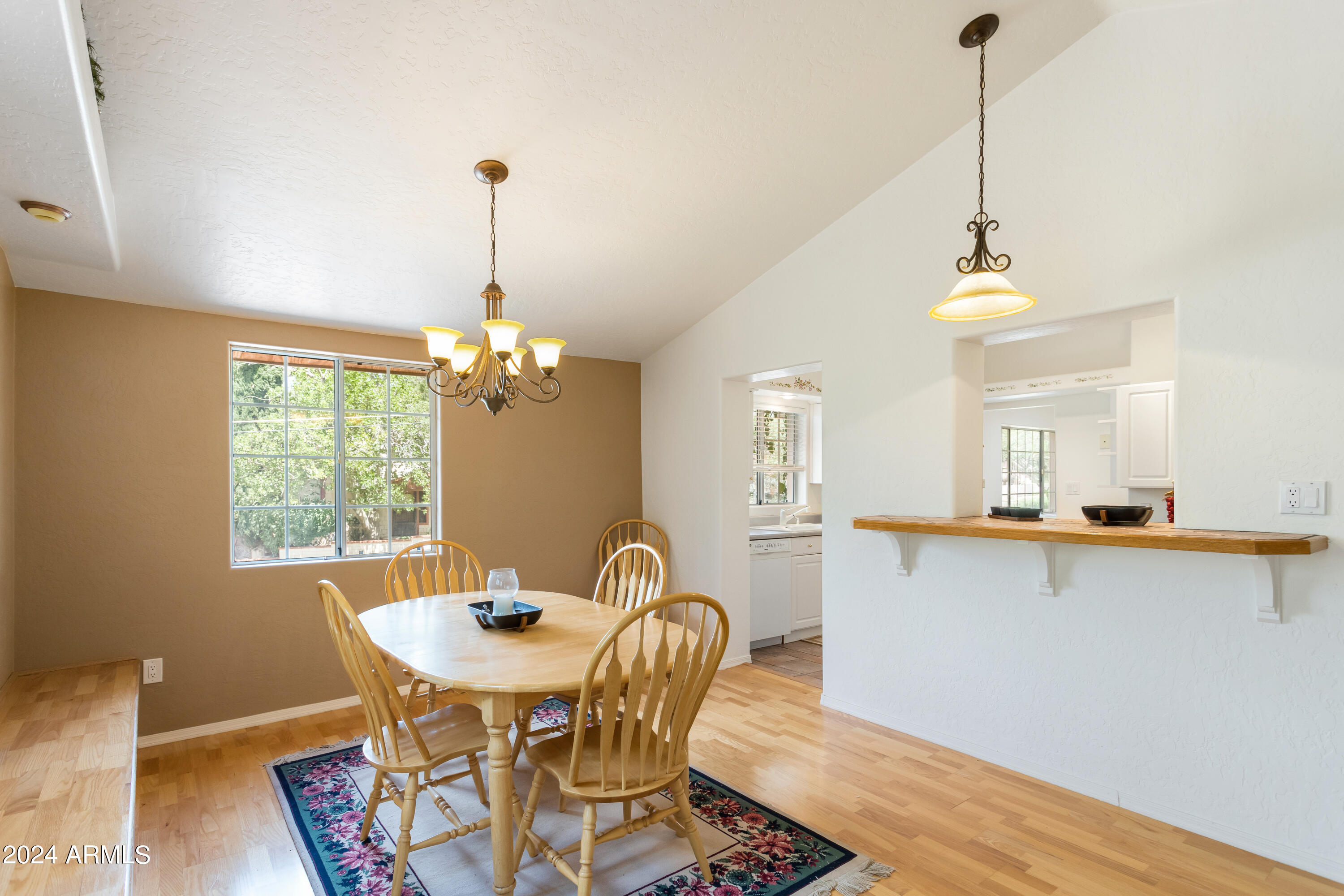 706 Shattuck Street Bisbee, AZ 85603 - Photo 17 of 55 a dining room with furniture a chandelier and wooden floor