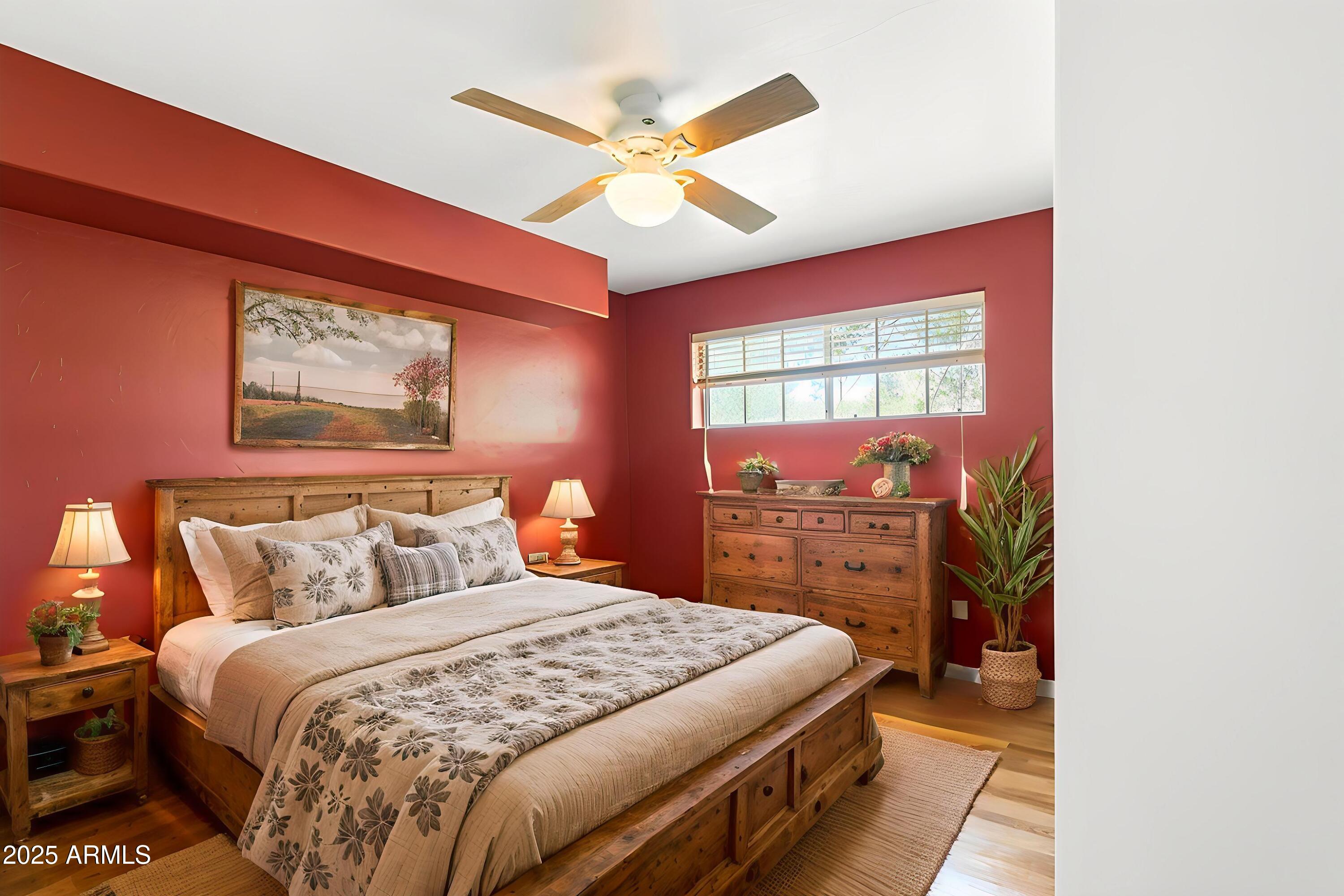 706 Shattuck Street Bisbee, AZ 85603 - Photo 21 of 55 a bedroom with a bed and a chandelier