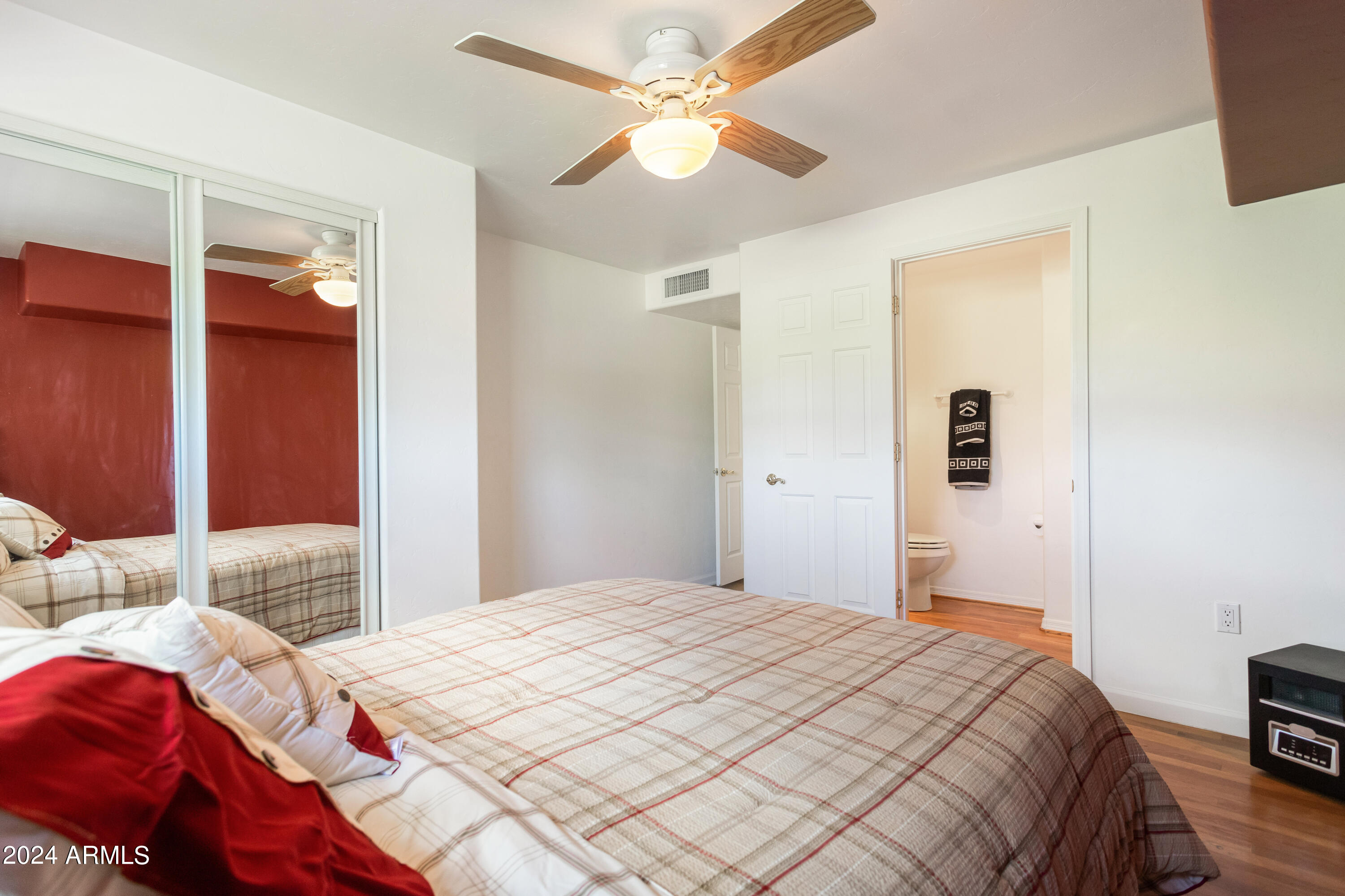 706 Shattuck Street Bisbee, AZ 85603 - Photo 23 of 55 a bedroom with a bed and a chandelier