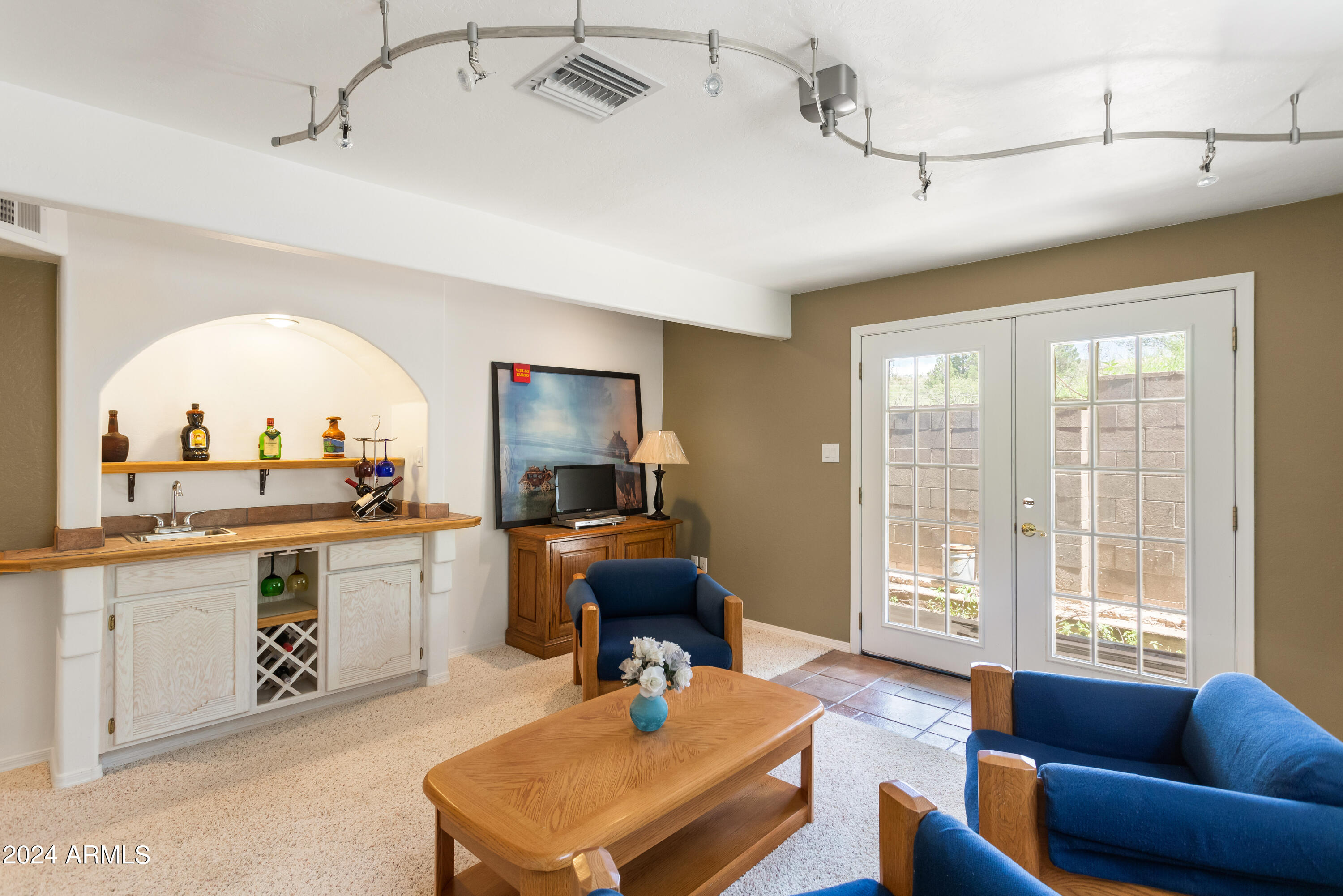 706 Shattuck Street Bisbee, AZ 85603 - Photo 26 of 55 a living room with furniture a fireplace and a flat screen tv