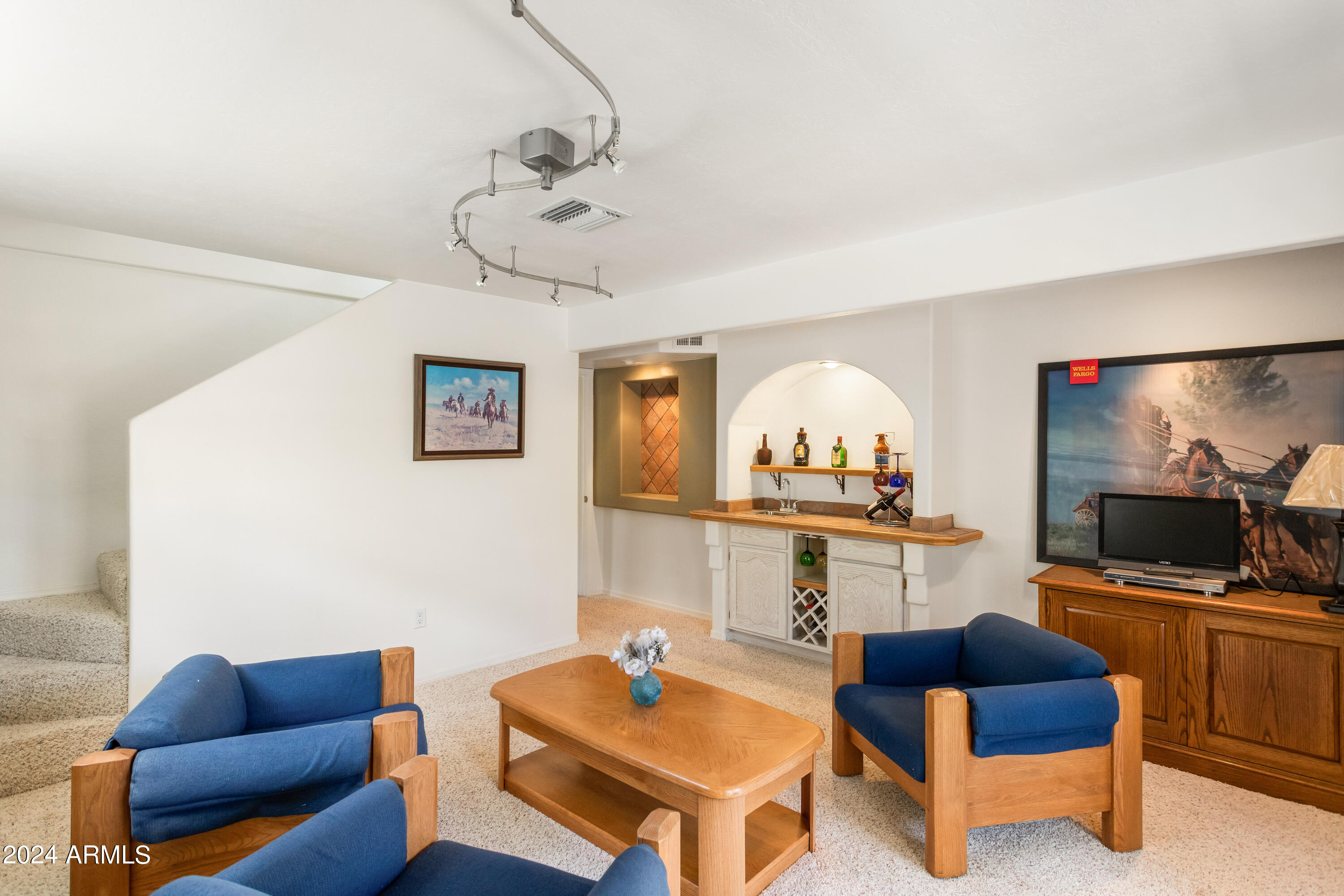 706 Shattuck Street Bisbee, AZ 85603 - Photo 27 of 55 a living room with furniture a flat screen tv and kitchen view