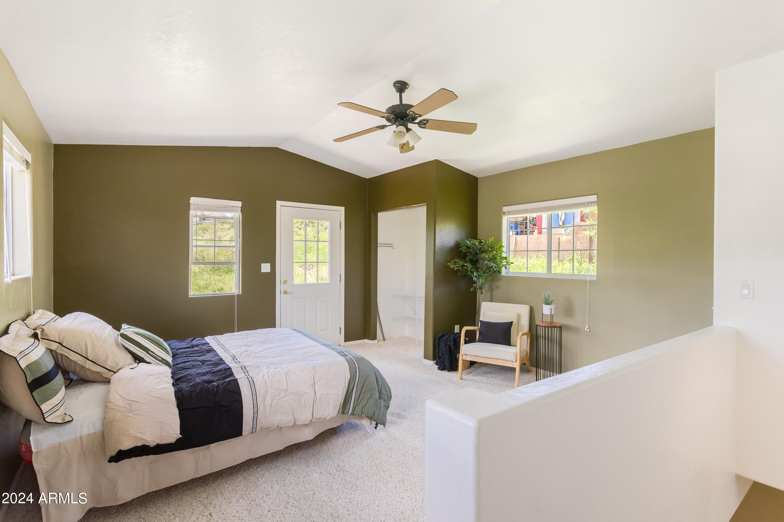 706 Shattuck Street Bisbee, AZ 85603 - Photo 28 of 55 a bedroom with a bed and a chandelier