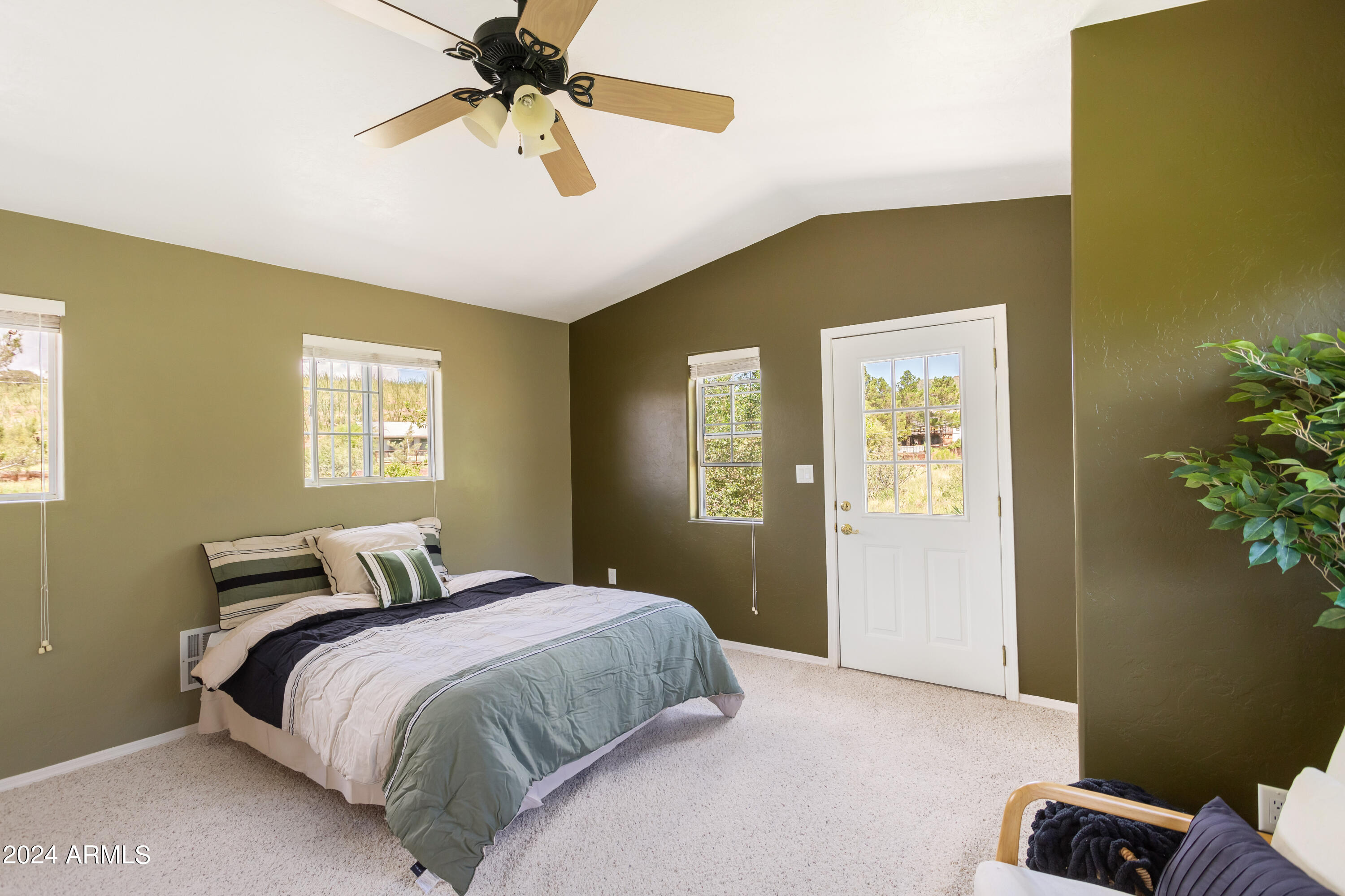 706 Shattuck Street Bisbee, AZ 85603 - Photo 29 of 55 a bedroom with a bed and a chandelier
