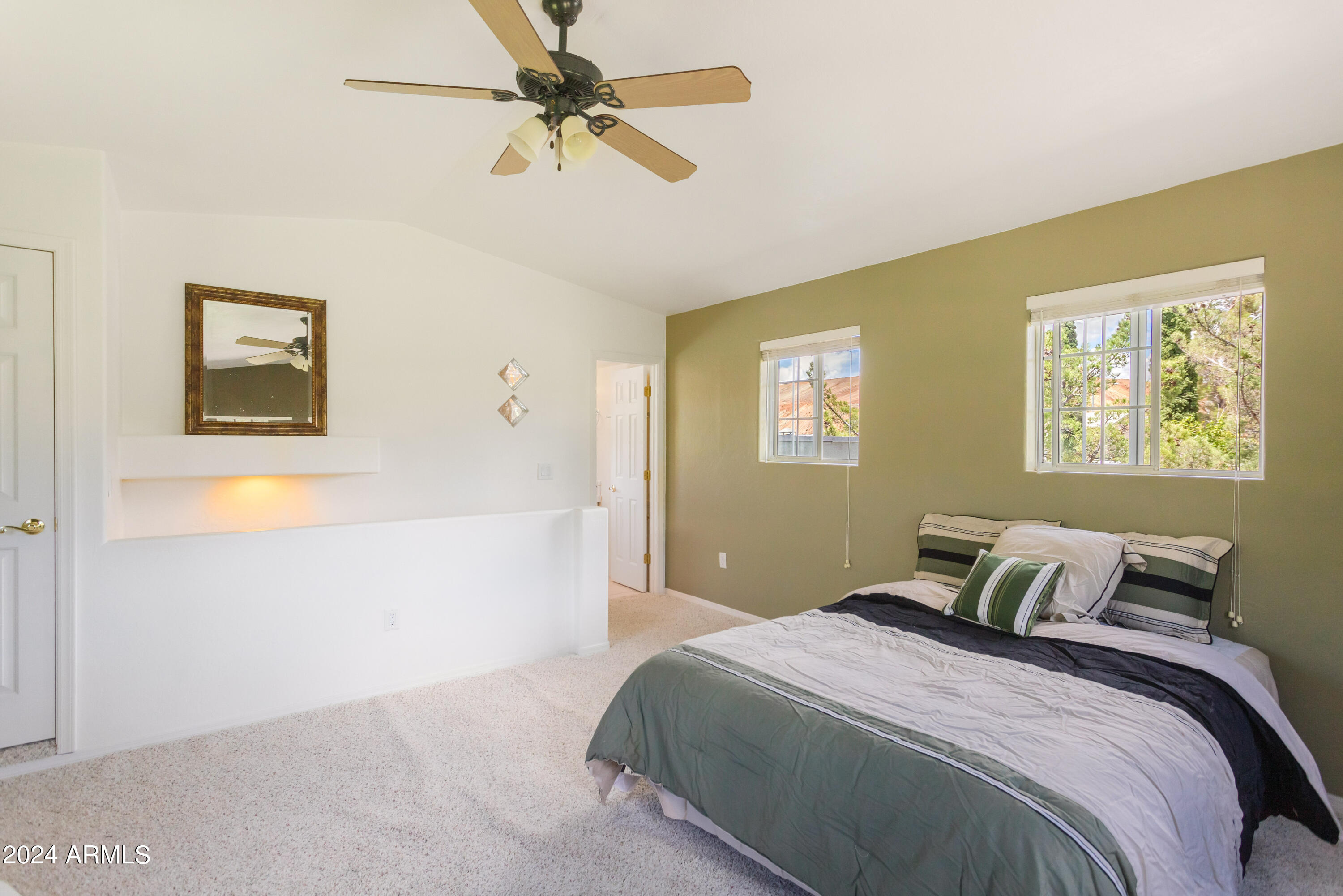 706 Shattuck Street Bisbee, AZ 85603 - Photo 30 of 55 a bedroom with a bed and a painting on the wall
