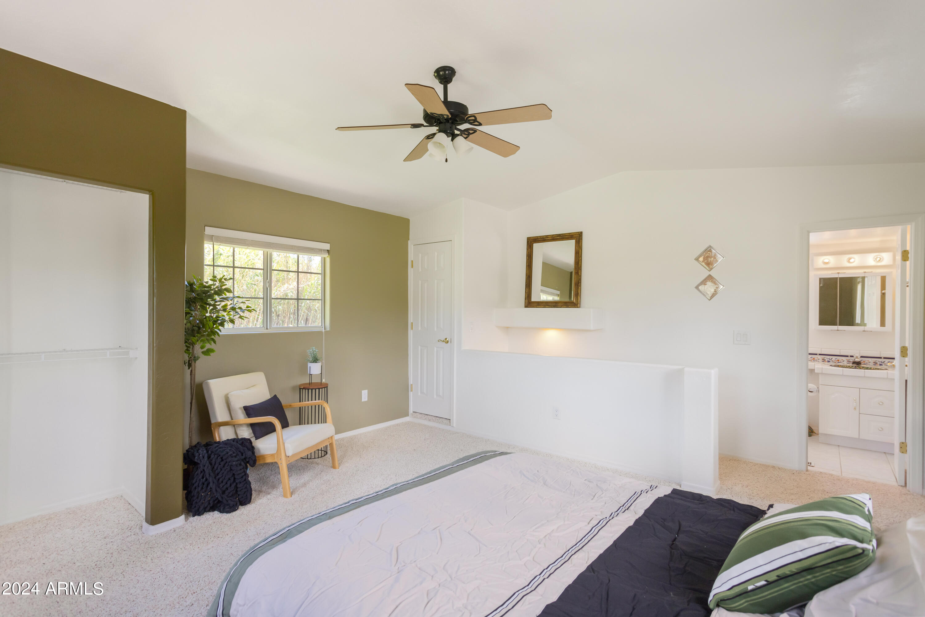 706 Shattuck Street Bisbee, AZ 85603 - Photo 31 of 55 a bedroom with a bed and wooden floor