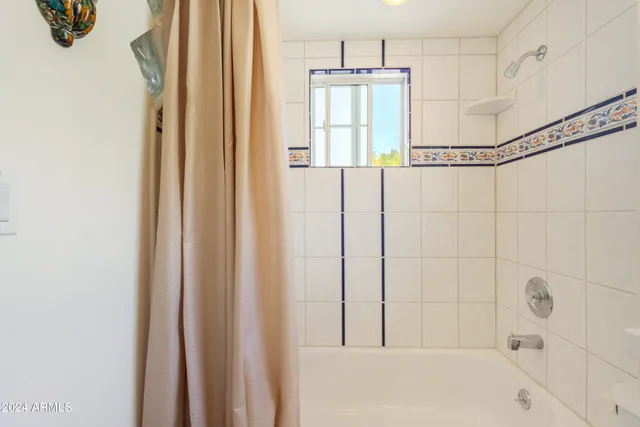 a bathroom with a bathtub and shower