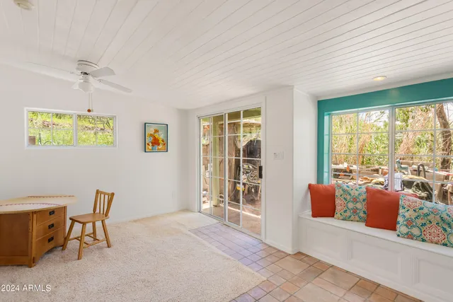 a living room with furniture and a floor to ceiling window