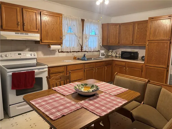 a kitchen with a sink a stove a table and chairs