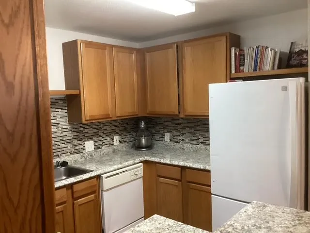 a view of a dining room with furniture and window