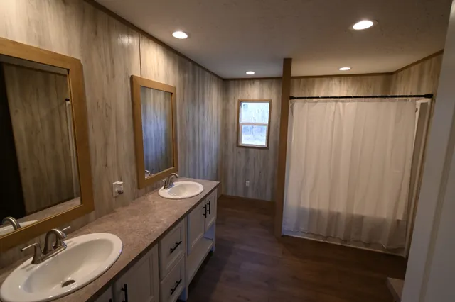 a front view of a house with a yard and mountain view in back