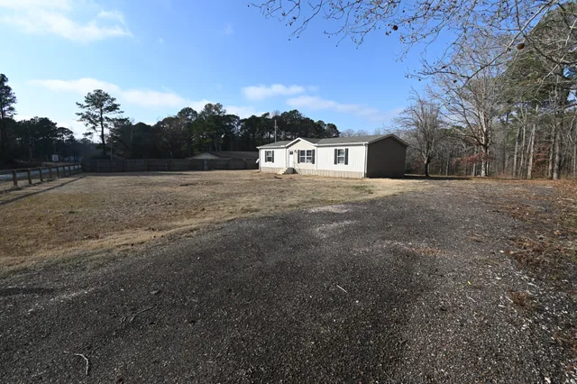 a kitchen with stainless steel appliances granite countertop a refrigerator a sink dishwasher a stove and a refrigerator with wooden floor