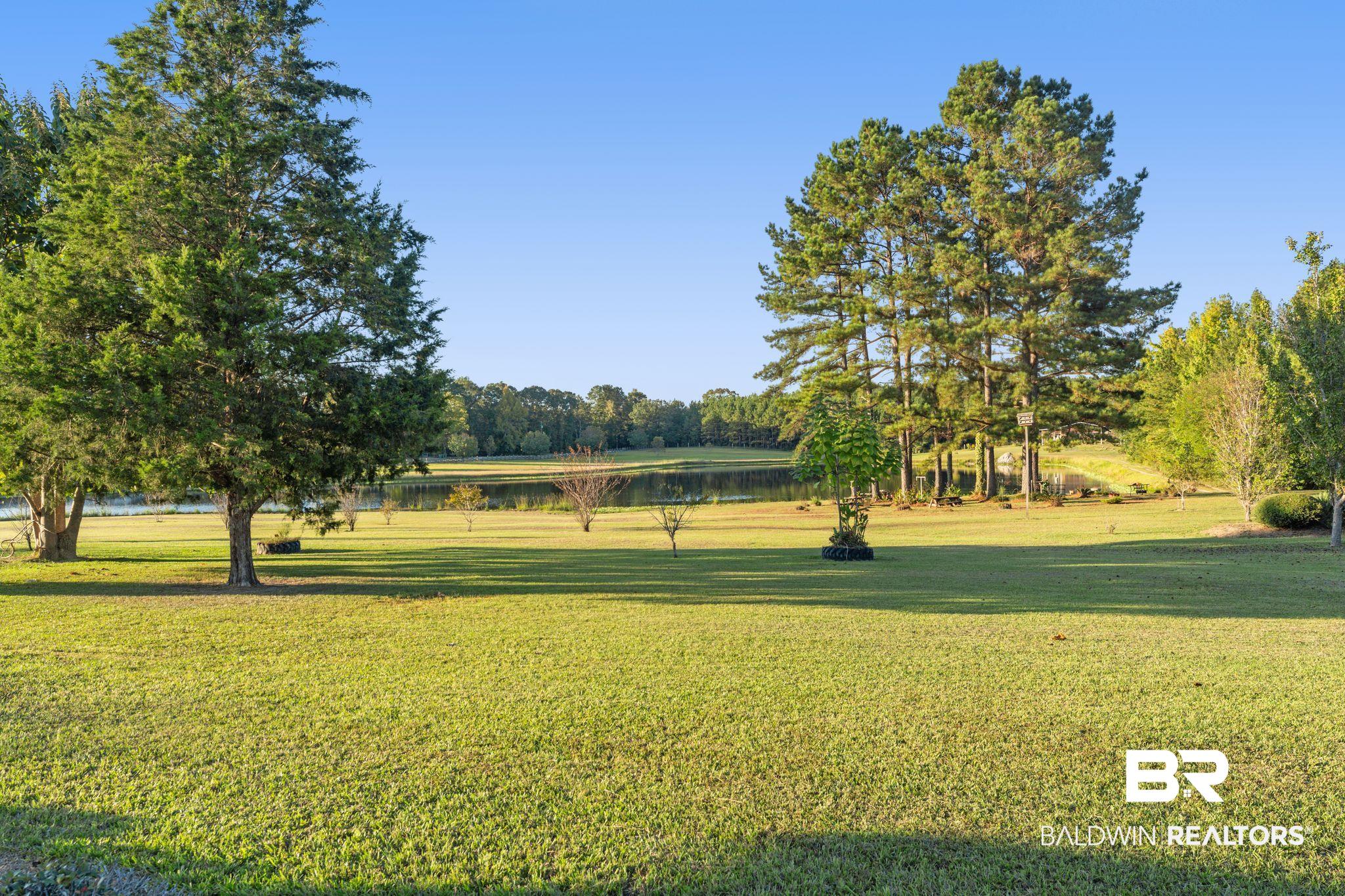 888 Mobile Cut-Off Road St. Stephens, AL 36569 - Photo 33 of 54 Surrounding community with a lawn and a water view
