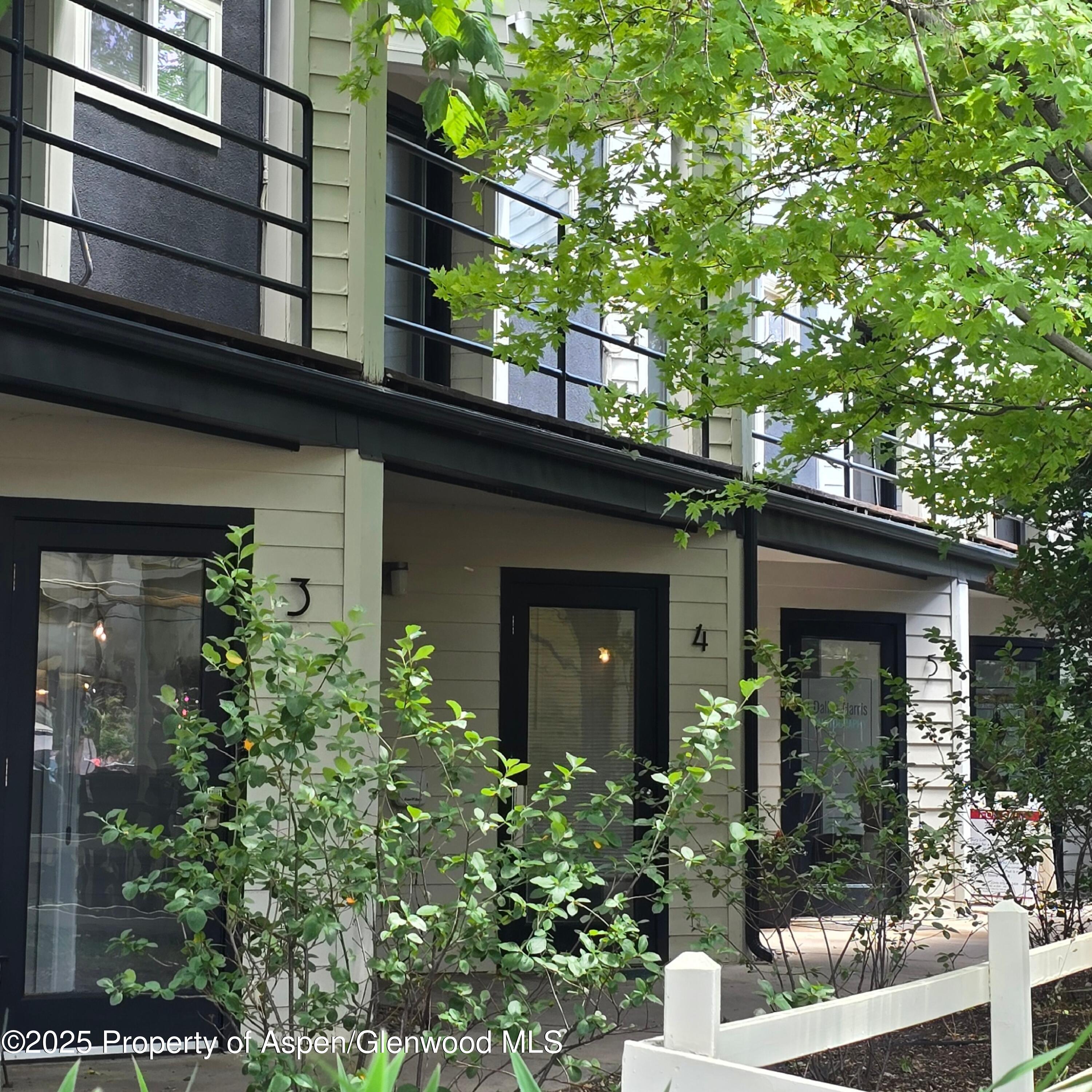a view of a house with a tree