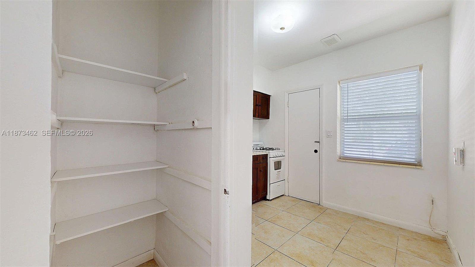 2499 Southwest 27th Street, Unit 7 Miami, FL 33133 - Photo 11 of 16 a view of an empty room with a window