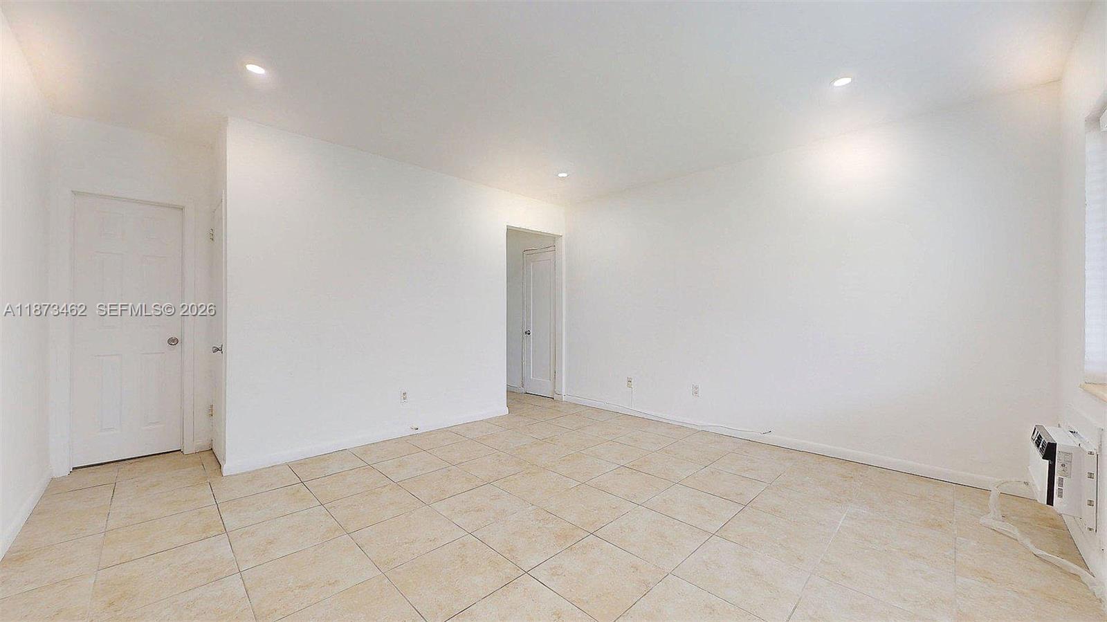 2499 Southwest 27th Street, Unit 7 Miami, FL 33133 - Photo 6 of 16 an empty room with white walls and tiles