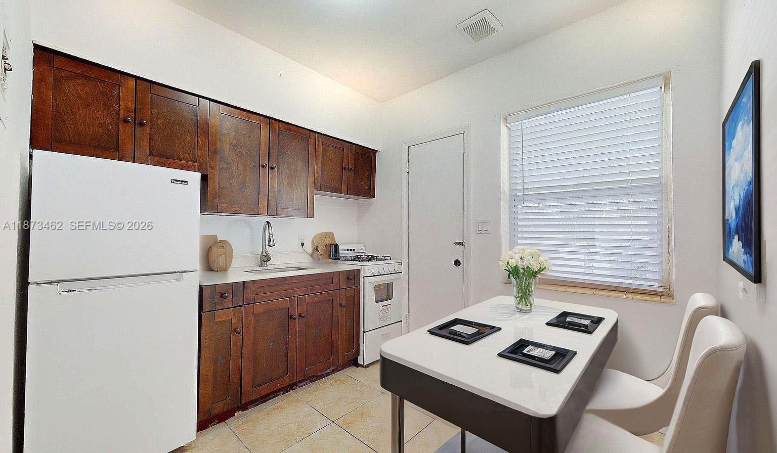 2499 Southwest 27th Street, Unit 7 Miami, FL 33133 - Photo 8 of 16 a kitchen with appliances cabinets and a counter top space