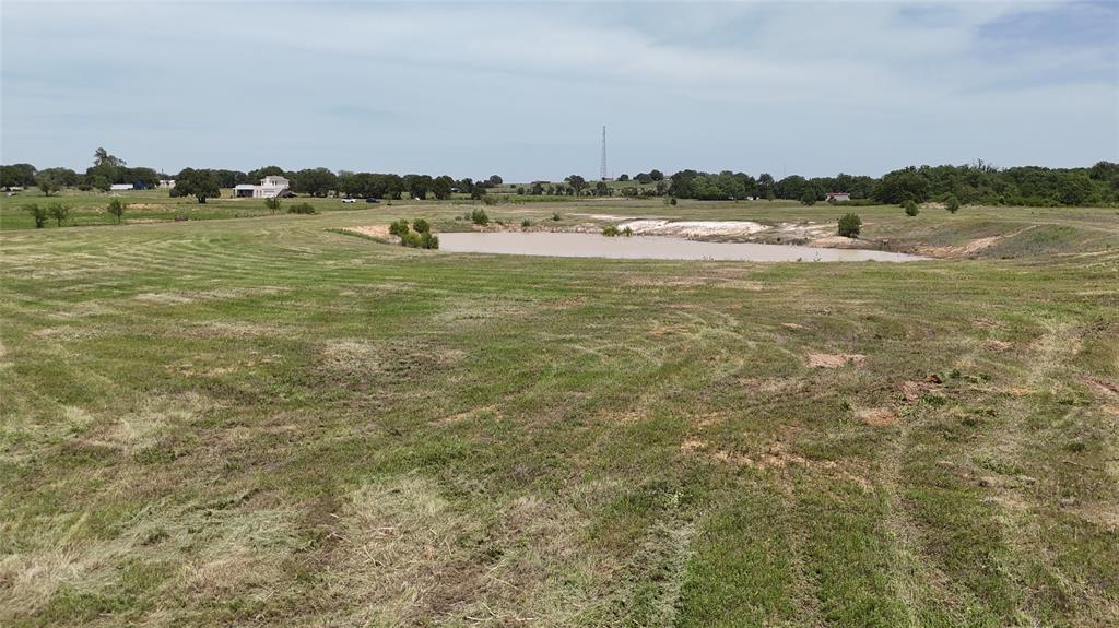 8605 West Highway 199 Springtown, TX 76082 - Photo 15 of 23 Expansive green acreage featuring a natural pond and distant tree lines