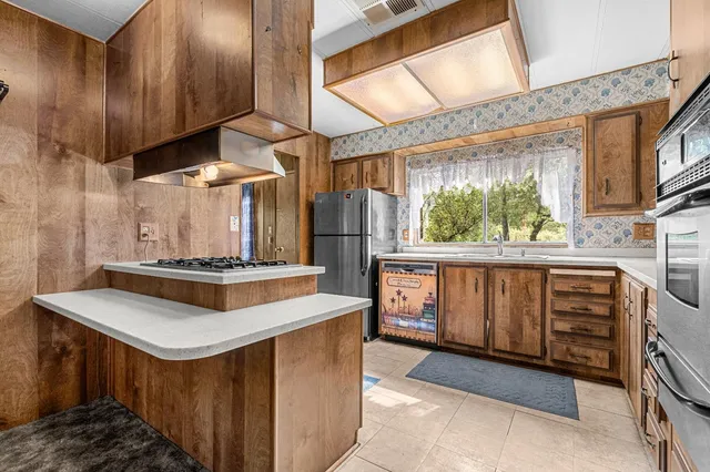 a kitchen with a stove and a refrigerator