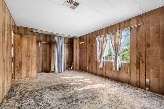a bathroom with a bathtub and next to a window