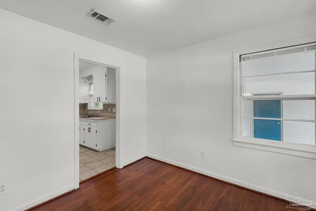 a kitchen with a stove sink and cabinets