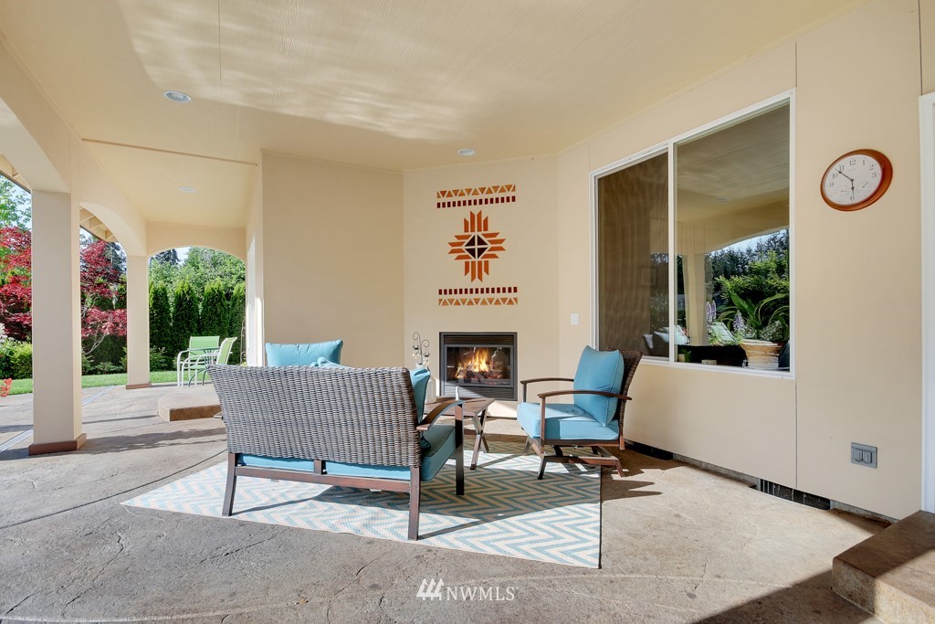 9908 Meadow Road Southwest Lakewood, WA 98499 - Photo 19 of 25 a living room with furniture a fireplace and a table