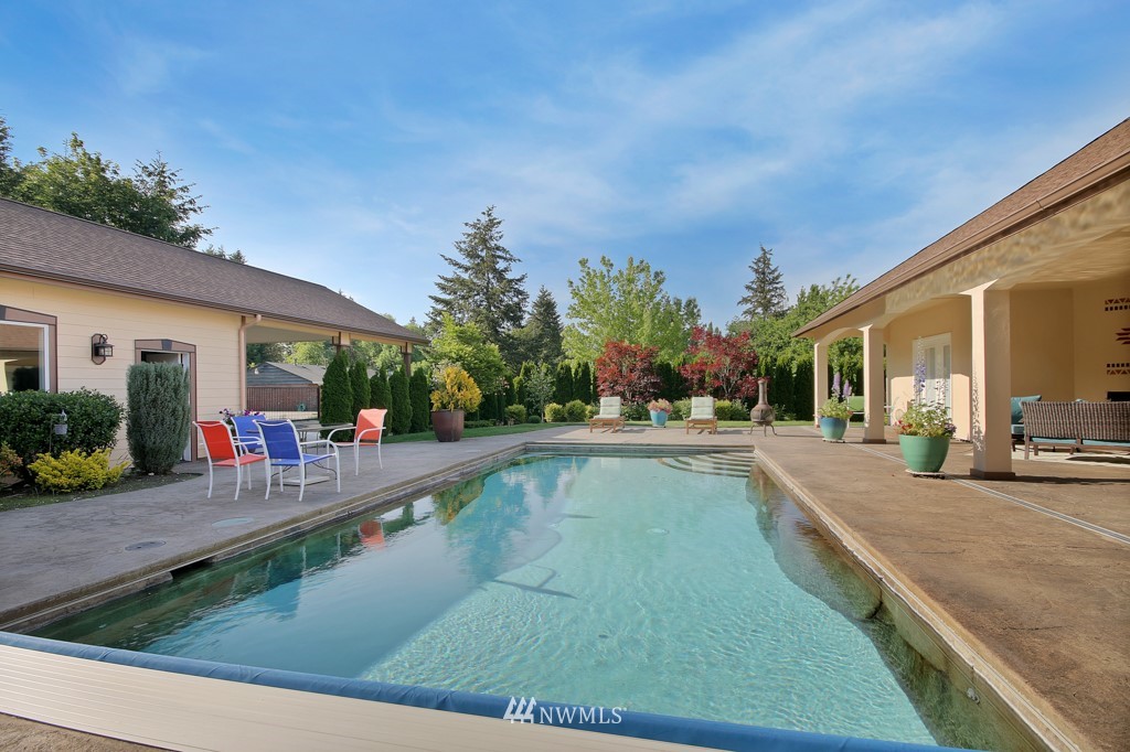 9908 Meadow Road Southwest Lakewood, WA 98499 - Photo 20 of 25 a view of a house with backyard patio and swimming pool