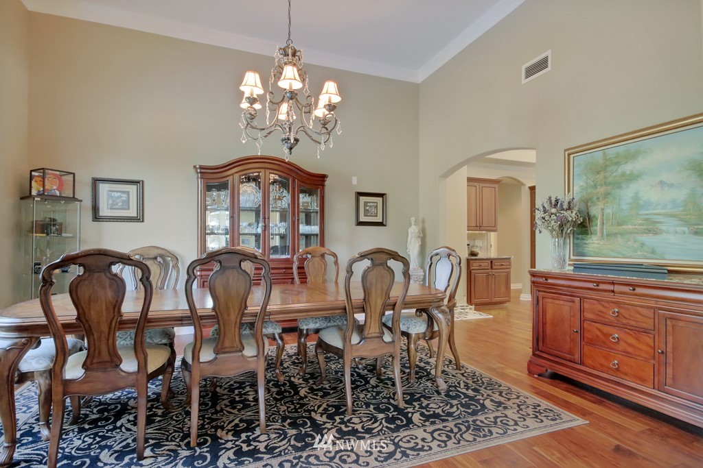 9908 Meadow Road Southwest Lakewood, WA 98499 - Photo 3 of 25 a view of a dining room with furniture a chandelier and wooden floor