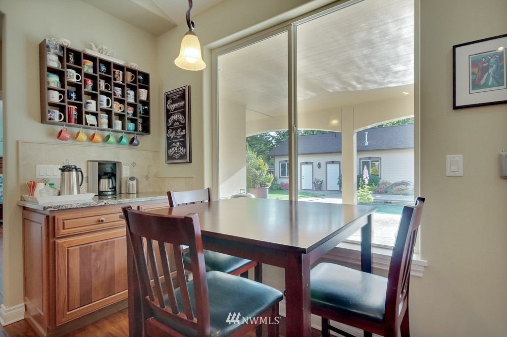 9908 Meadow Road Southwest Lakewood, WA 98499 - Photo 7 of 25 a view of a dining room with furniture window and wooden floor