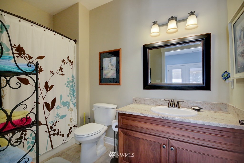 9908 Meadow Road Southwest Lakewood, WA 98499 - Photo 10 of 25 a bathroom with a sink vanity mirror and toilet