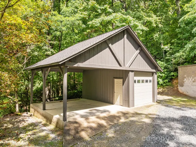 a view of a house with a yard and tree