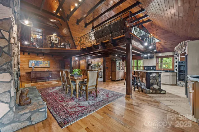 a view of a big room with table chairs and a wooden floor