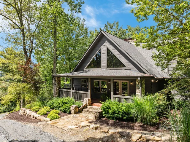 a front view of a house with a garden and plants