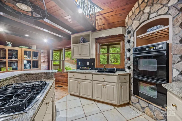 a kitchen with stainless steel appliances a stove a sink and a microwave