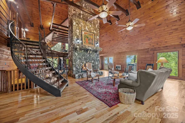 a living room with fireplace furniture and a wooden floor