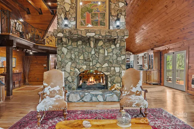 a living room with fireplace furniture and wooden floor
