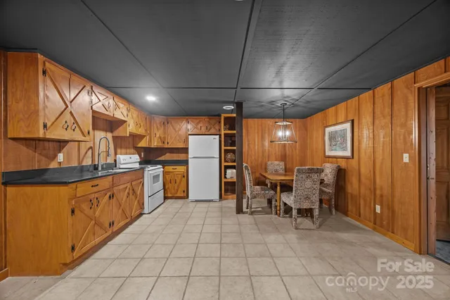 a kitchen with granite countertop a sink and white cabinets