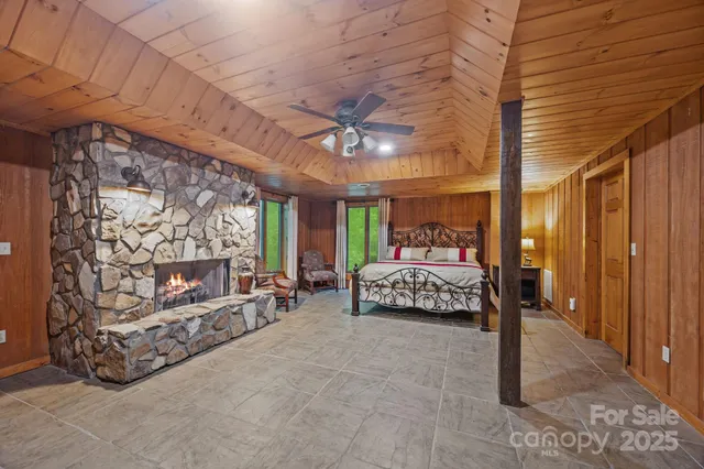 a bedroom with bed and a large window