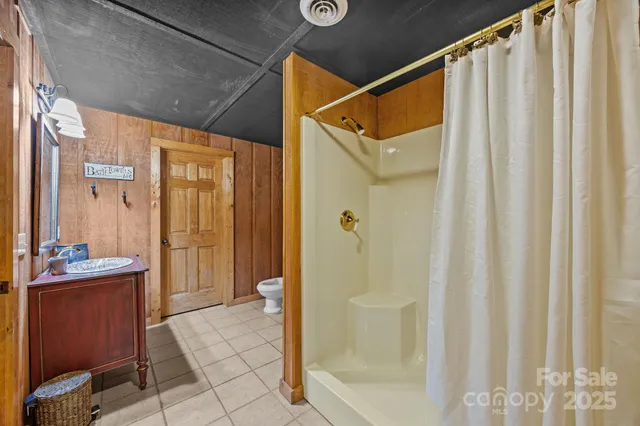 a bathroom with a shower and a sink