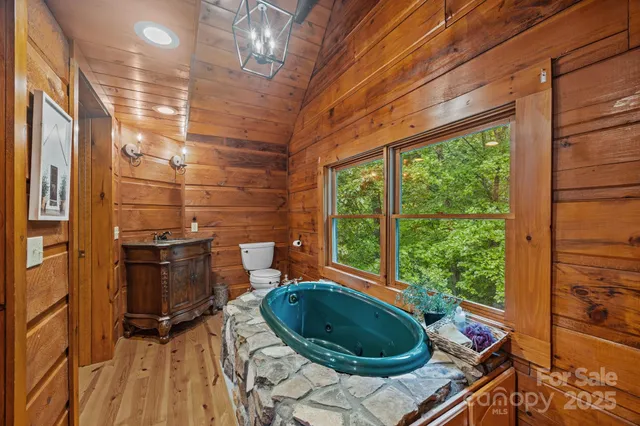 a living room with a sink and wooden floor