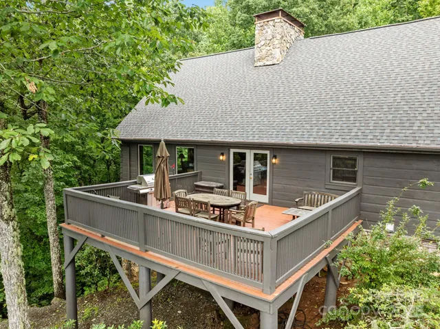 a view of house with roof deck and seating space