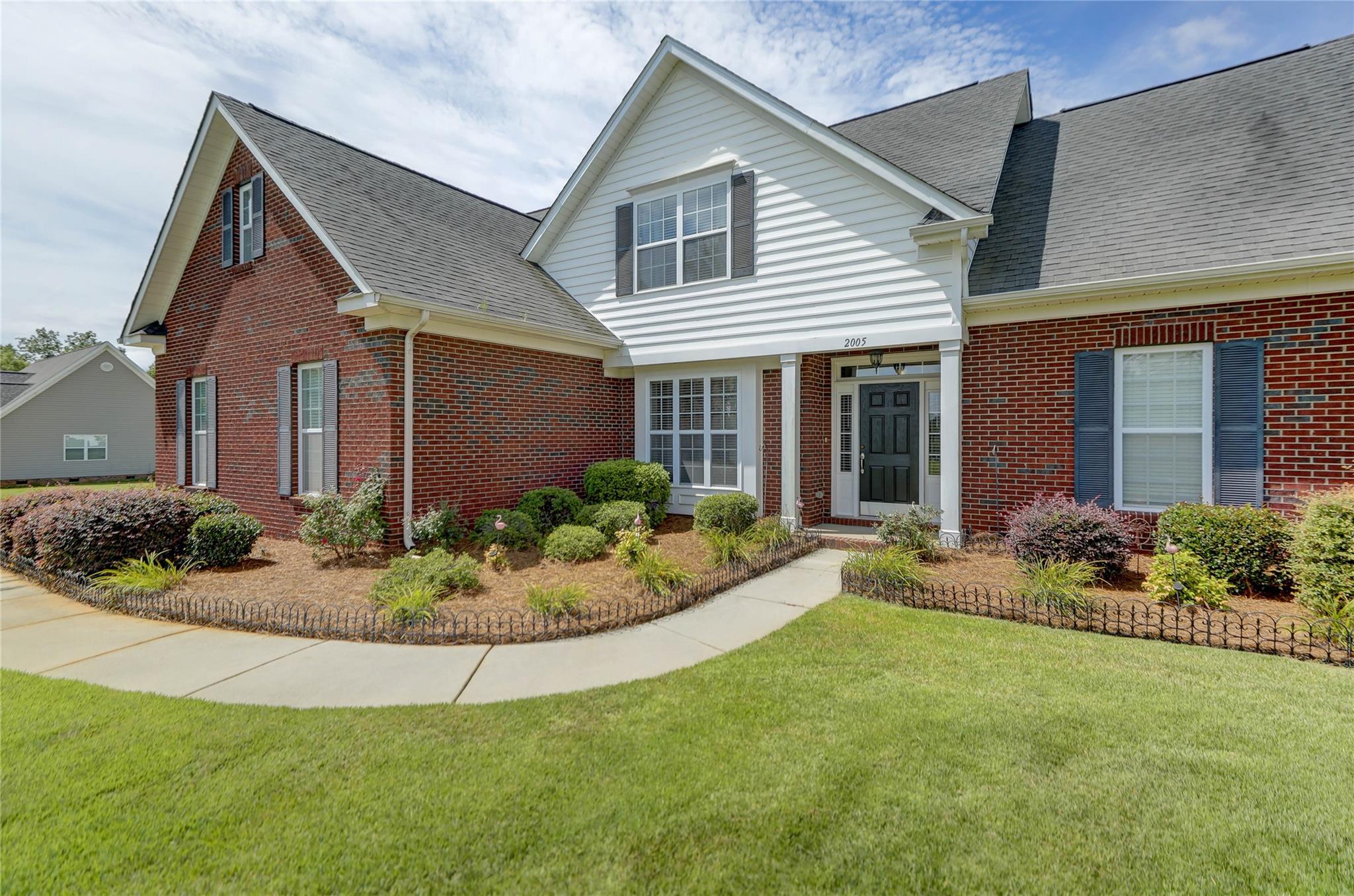 2005 Charles Avenue Lancaster, SC 29720 - Photo 3 of 42 a front view of a house with a yard and potted plants