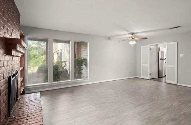 wooden floor in an empty room with a fireplace