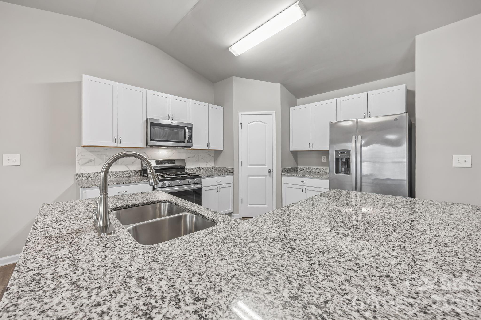 1219 Amberlight Circle Salisbury, NC 28144 - Photo 15 of 30 a kitchen with granite countertop a refrigerator and a sink