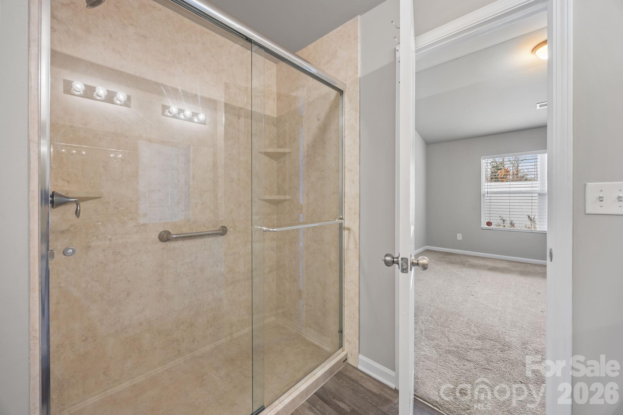 1219 Amberlight Circle Salisbury, NC 28144 - Photo 23 of 30 a bathroom with a glass shower door