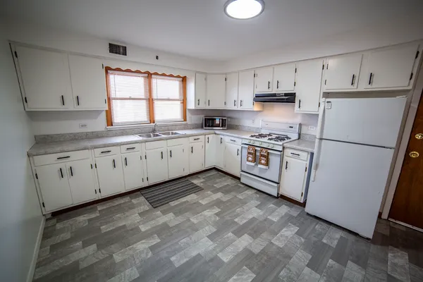 a kitchen with appliances cabinets and a sink