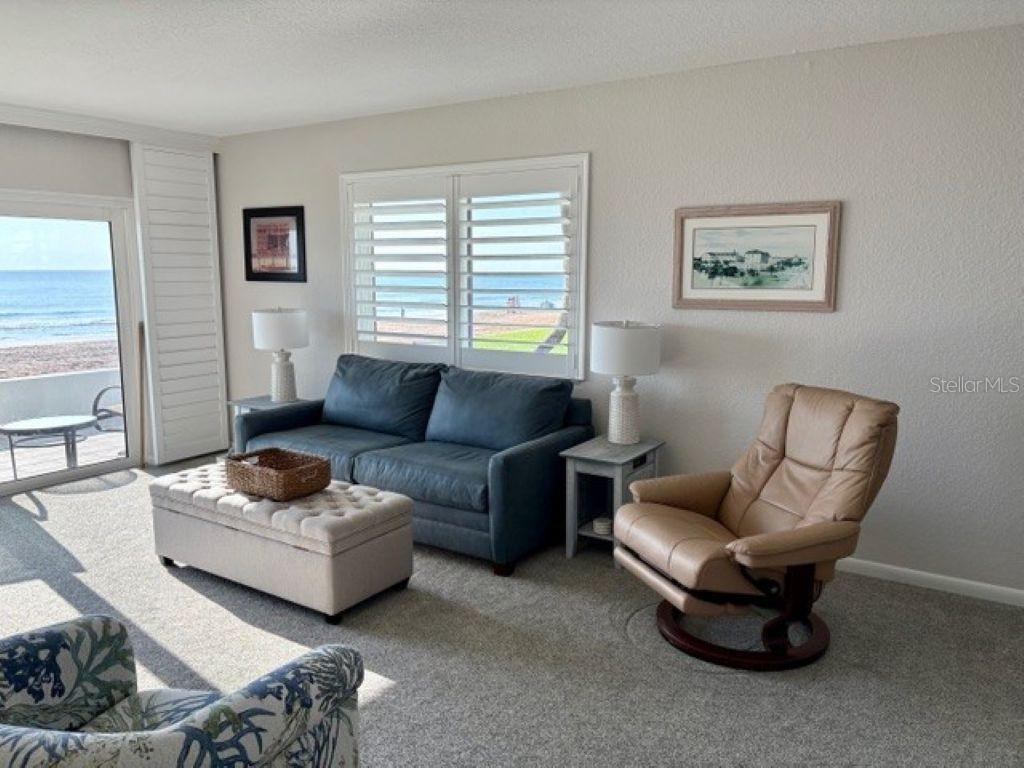 815 Ocean Shore Boulevard, Unit 13 Ormond Beach, FL 32176 - Photo 16 of 17 a living room with furniture and a window