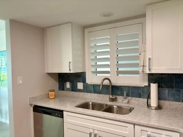 a kitchen with a sink and a window