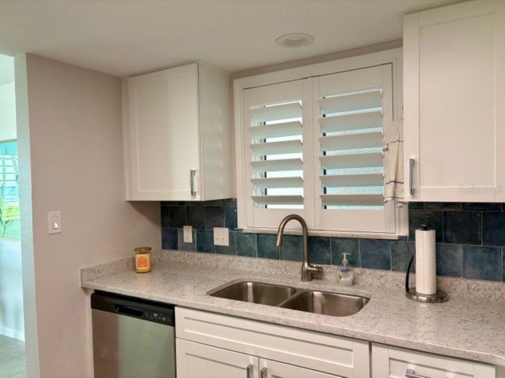 815 Ocean Shore Boulevard, Unit 13 Ormond Beach, FL 32176 - Photo 17 of 17 a kitchen with a sink and a window