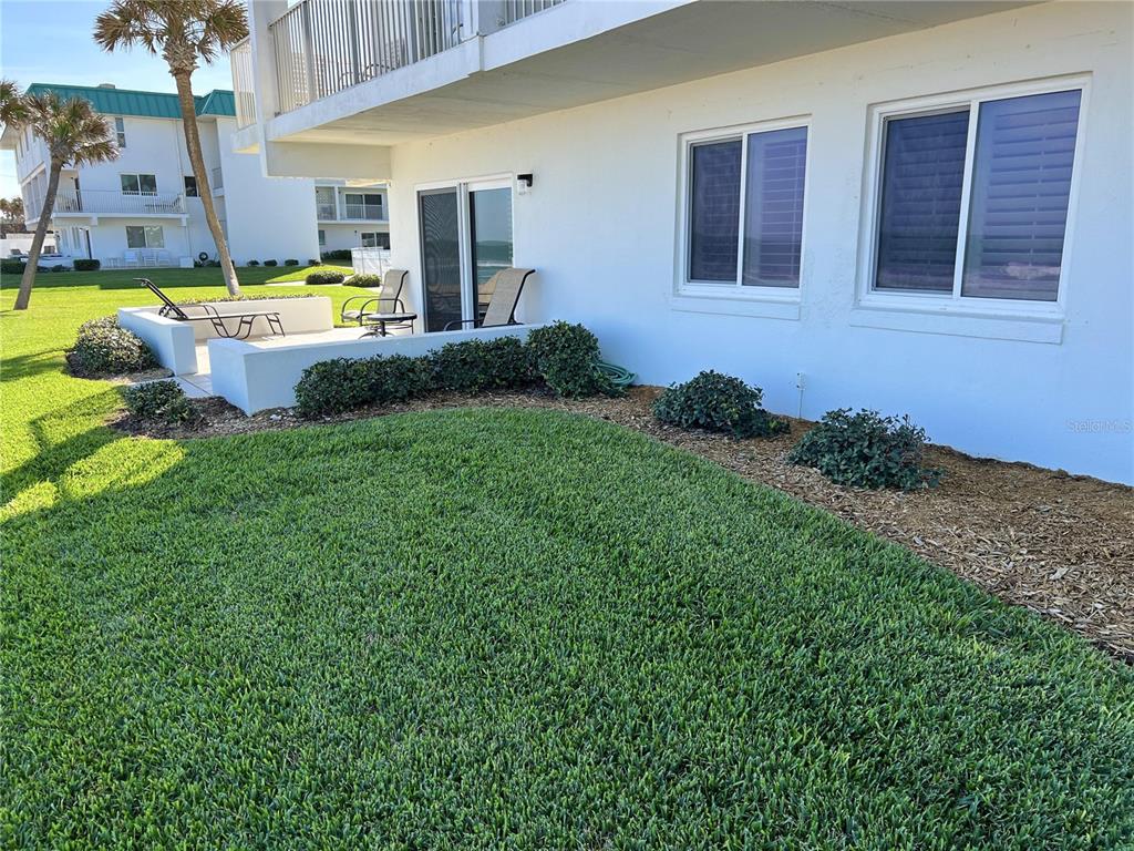815 Ocean Shore Boulevard, Unit 13 Ormond Beach, FL 32176 - Photo 6 of 17 a house view with a sitting space and garden